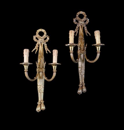 Coppia di appliques in metallo dorato - a due luci su bracci arcuati e...