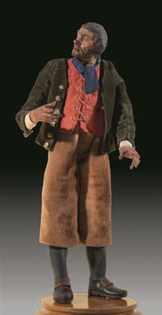 Contadino con gilet rosso e giacca marrone su pantaloni in velluto beige....