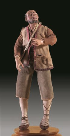 Rustico con barba, indossa un gilet e pantaloni in tela marrone, calzato con...