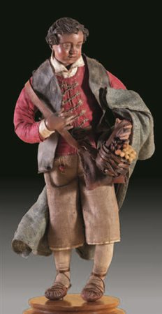 Giovane pastore vestito con una giacca rossa, pantaloni in tela rustica e...