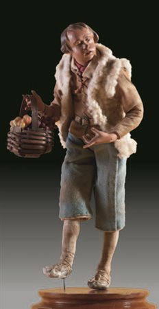 Giovane pastore con giacca e pantaloni in tela rustica e gilet in lana a...