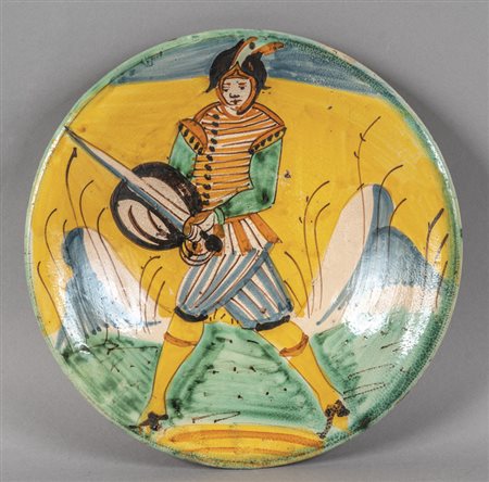Piatto in maiolica policroma con al centro 