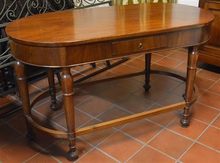 Tavolo ovale lastronato in noce a sei gambe unite da traverse e con un...