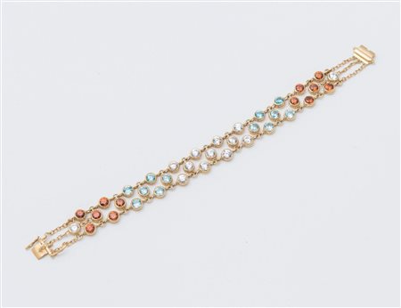 BRACCIALE IN ORO E PIETRE in oro giallo 18K, decorato a tre file di pietre...