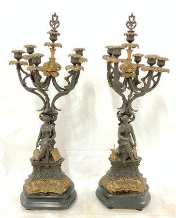 Coppia di candelabri a sei fiamme in metallo brunito e dorato con fusti a figur