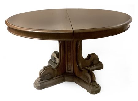 Tavolo allungabile lastronato di forma ovale poggiante su gamba centrale a colo