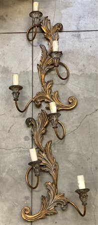 Coppia di appliques a tre luci con struttura in metallo, decorate con foglie e