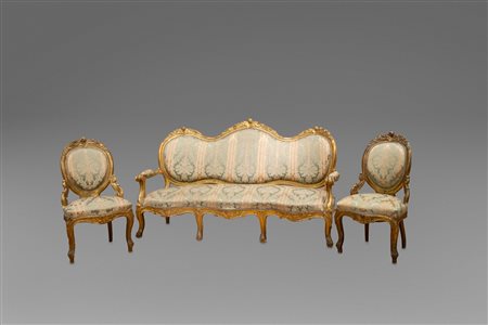 Otto poltroncine e un divano a tre posti in legno intagliato e dorato, a motivi vegetali e volute, XIX secolo