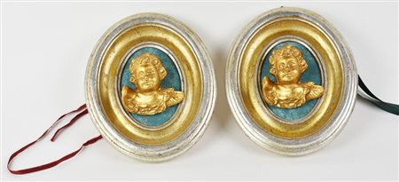 COPPIA DI ANGIOLETTI in legno scolpito e dorato entro cornici meccate, cm...