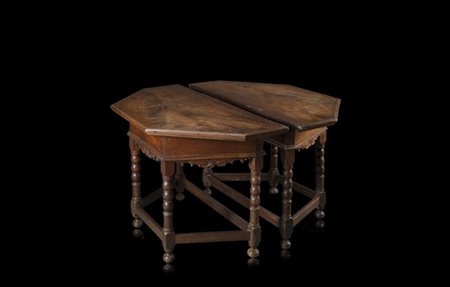 Coppia di tavoli a muro con piani esagonali e fasce intagliate a volute, gambe