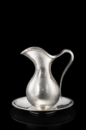 Versatoio con piatto in argento martellato, profili cordonati. Titolo 800. Arge