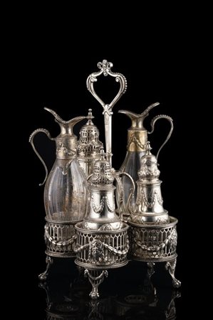 Cruet stand in argento con base sorretta da piedi ferini, traforata e decorata