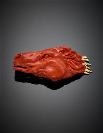 Spilla a guisa di testa di cavallo in corallo arancione rifinito in oro giallo