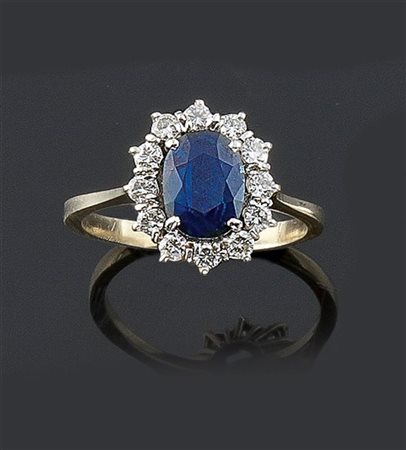 ANELLO Anello in oro bianco, sommità a forma di fiore, con al centro zaffiro...