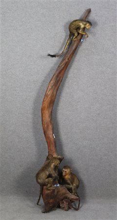 Three stuffed macaques on a tree branch