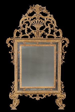 Specchiera in legno intagliato e laccato di forma rettangolare tripartita. Cima