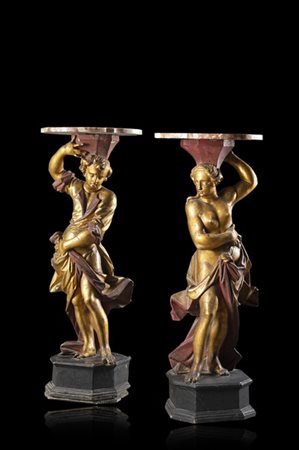 Coppia di gueridons in legno intagliato, laccato e dorato. Sostegno a figure a