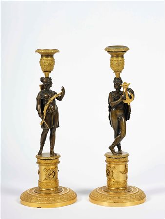 Coppia di candelieri. Bronzo fuso, cesellato, patinato e dorato. Fonditore...