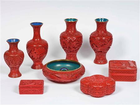 Gruppo di oggetti in lacca rossa con decori floreali e figure di fenici,...