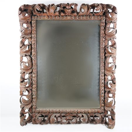 Specchiera con cornice di legno laccato e riccamente intagliato a corpose...