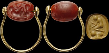 An etruscan carnelian scarab intaglio set on a modern gold ring. Male figure and animal. 
