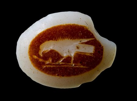 A roman double-layered agate intaglio. Bird (crow) with a leafy branch.