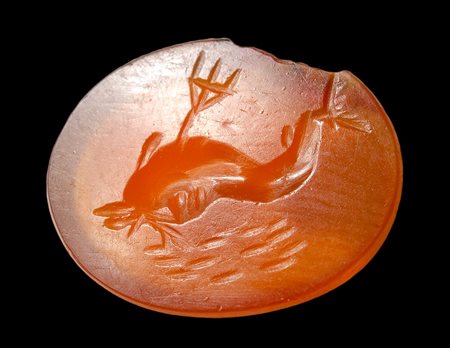 A roman carnelian intaglio. Dolphin with a trident.
