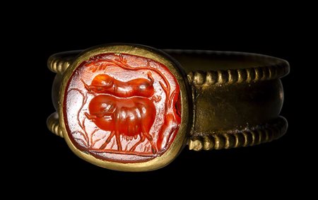 A roman carnelian intaglio set in a Postclassical gold ring. Two pigs. 