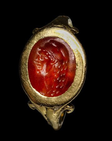 A roman carnelian intaglio mounted in a postclassical gold ring. Herakles portrait. 