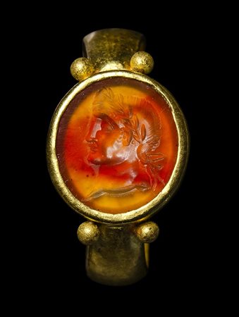 A north-european roman gold ring set with a carnelian intaglio. Emperor portrait. 