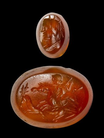 A lot of 2 roman intaglios. Bust of Helios and hunting scene.