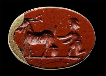 A roman red jasper intaglio set in a modern gold mounting. Shepherd and goat. 