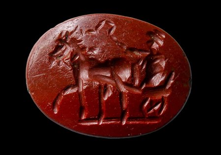 A roman red jasper intaglio. Male figure on his chariot. 