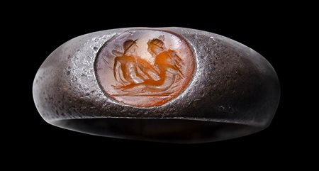 A roman silver ring set with a carnelian intaglio. Erotic scene.