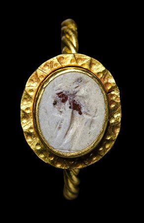 A lombardic gold ring set with a roman burnt agate intaglio. 