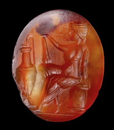 A roman agate carnelian intaglio. Toilette scene. 