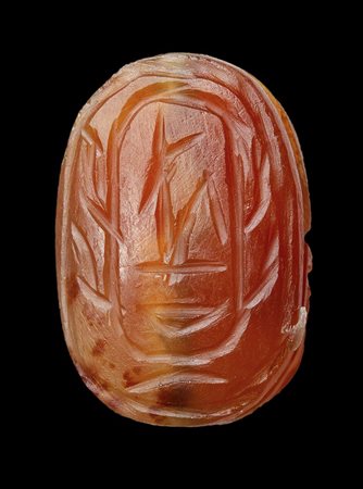 An Egyptian ptolemaic carnelian scarab. 