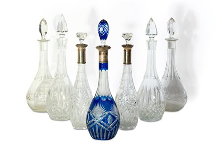 Sette bottiglie in cristallo, tre con collo in argento