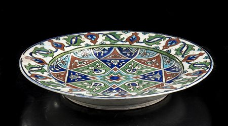 PIATTO IN CERAMICA 'IZNIK' INVETRIATA E DIPINTA 
Turchia, XVI secolo