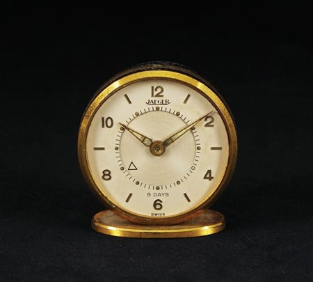 Jaeger pendulette di forma circolare con cassa in metallo dorato. Anni '30,...