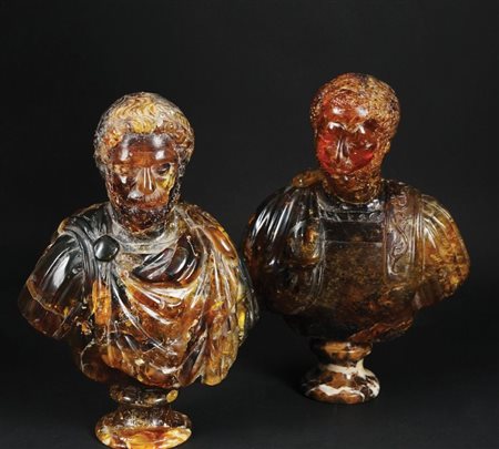 Due sculture in ambra ciascuna raffigurante un busto di imperatore romano; un...