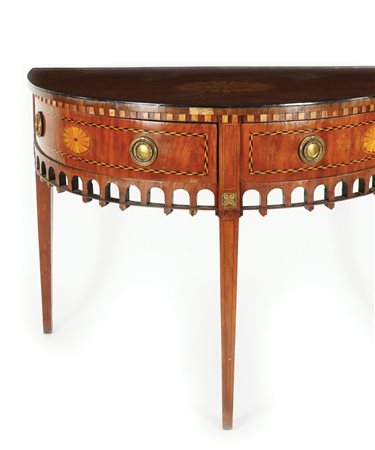 Console a mezzaluna impiallacciata in mogano. Piano centrato da una riserva...