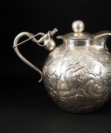 Teiera con corpo globulare in argento finemente sbalzato a figure di draghi...
