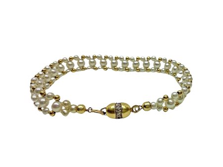 Bracciale in oro giallo e lavorazione con perle  9.3 gr. sus