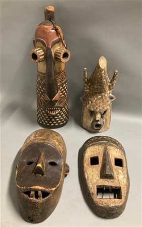 Arte africana, lotto di quattro maschere in legno scolpito e dipinto, etnie dif