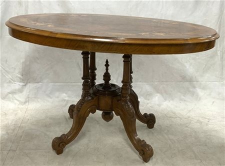 Tavolo con piano ovale lastronato e intarsiato a animali tra volute. Sostegno a