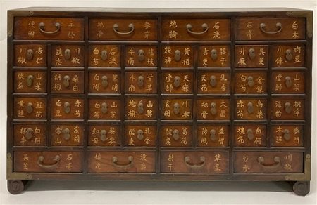 Mobiletto da farmacia in legno scuro, fronte a quaranta tiretti di varia misura