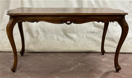 Tavolo da centro di forma mossa in legno intagliato, fascia decorata a volute f