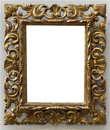 Antica cornice in legno intagliato, traforato e dorato a volute, valve di conch