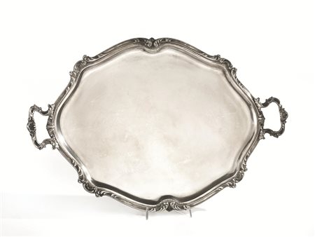 Vassoio, in argento, di forma ovale sagomata e due manici cesellati a volute...